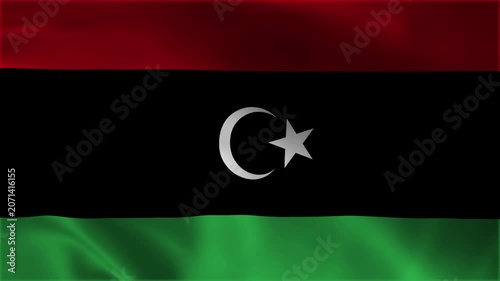 Libya national flag waving in loop seamless background video, close up of the libyan tricolor banner featuring a white crescent and star emblem on black red and green stripes graphic backdrop.