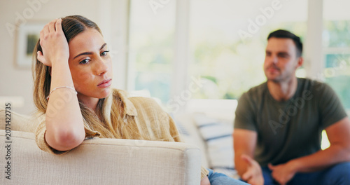 Photos Stress, fighting and woman on sofa in home for conflict, breakup or cheating problem in marriage