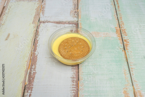 Photos A deep plate of custard, showing a spoon that has just taken the first bite, leaving a clean indentation and showing that it's creamy, not runny