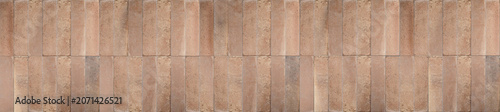 Quadro su tela Vertical beige and caramel ceramic tiles arranged in a continuous stacked bond pattern