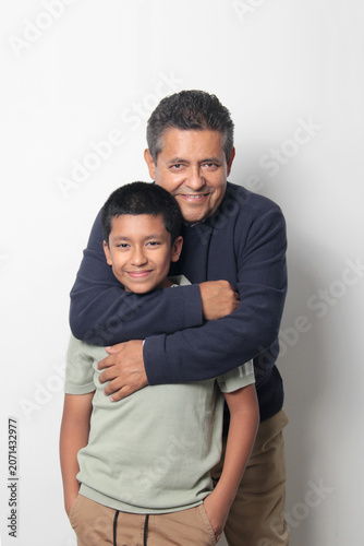 Latino single dad and his 12-year-old Latino son show their love to celebrate Father's Day