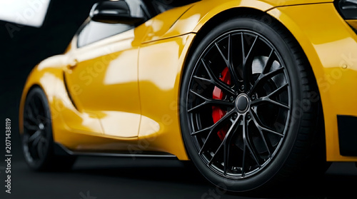 Close-up of a multi-spoke matte black alloy wheel on a yellow sports car with red brake calipers