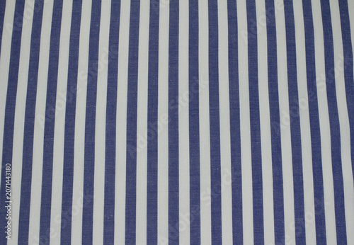 Texture of classic blue and white vertical striped fabric. Close up of blue striped cotton cloth background.