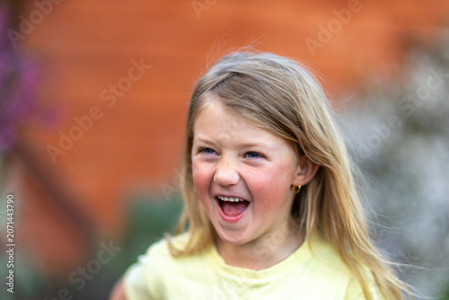 Child laughing joyfully during outdoor playtime