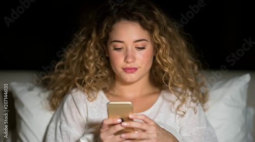 Excited curly blond woman is anticipating a date with a boyfriend after their match on a dating app
