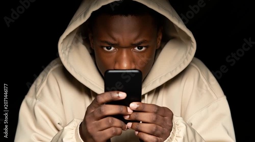 African American light Brown adolescent who is a content creator on social media is replying on comments from his followers