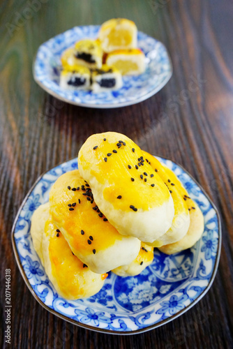 Chinese pastry in blue dish on wooden table