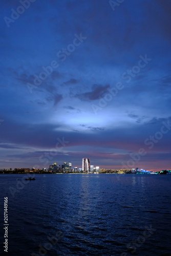 City skyline across water at blue hour