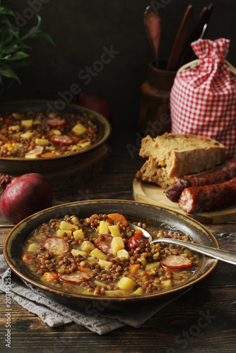 A bowl with traditional German Linsensuppe lentil soup in rustic style