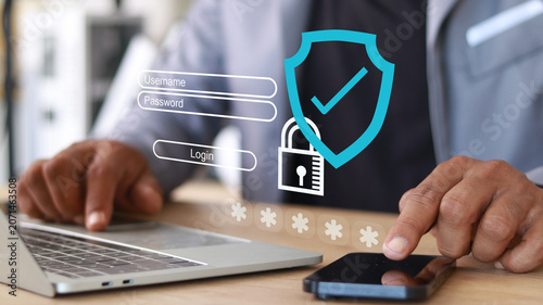 Obraz na plátně Business professional using laptop and smartphone with secure login interface, p