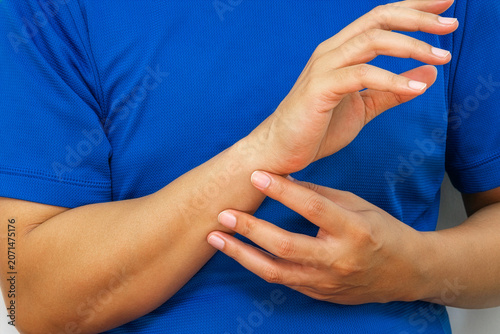 Εκτύπωση καμβά Person holding painful wrist, highlighting bone or nerve injury, medical treatment and rehabilitation concept for healthcare advertising