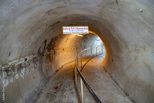 Konstfotografi A tunnel with a sign in Thai and English reading To the 2 nd heaven, Immortal happiness everyone