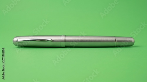 Pen in silver fountain style closed on green