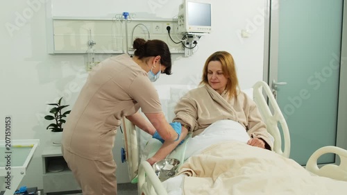 Doctor uses alcohol-soaked cotton pad to clean arm of patient. Physician wipes arm using disinfected cotton pad to ensure proper hygiene. Slow motion