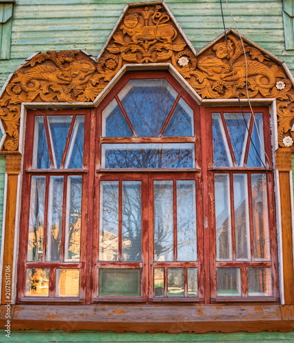 The window of an old wooden house with delicate carvings