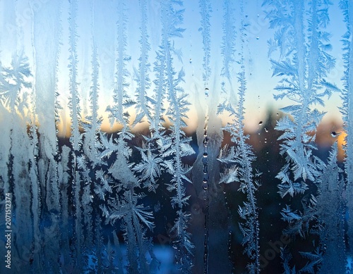 Frosted Glass Window with Ice Crystals and Condensation Droplets in Morning Light