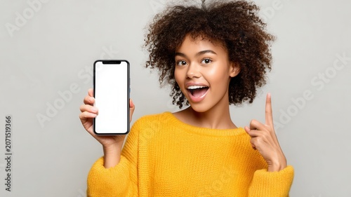 Excited woman showing blank smartphone screen presenting new mobile app service finger or product pointing