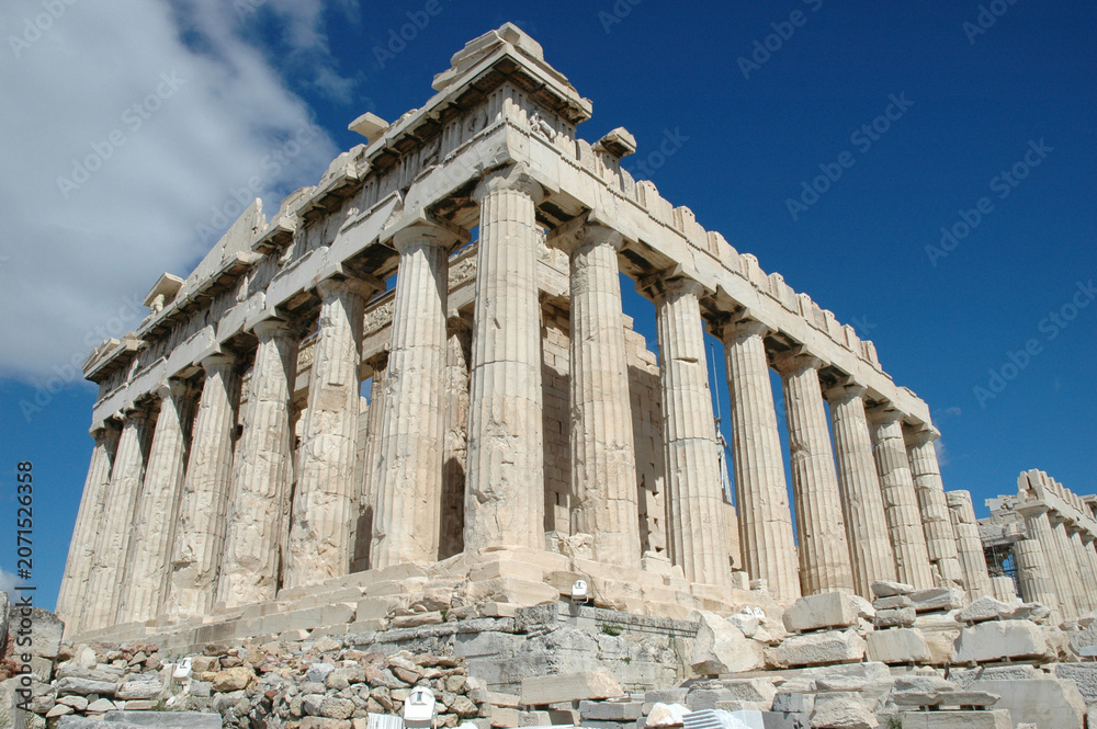 Fototapeta premium A low angle perspective of the majestic ancient Parthenon temple with its historic Doric columns under a deep blue sky in Athens Greece.
