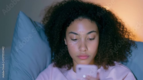 Curly light Brown freckled zoomer in puberty period wearing lilac satin pajamas is swiping profiles on the dating app. Always online