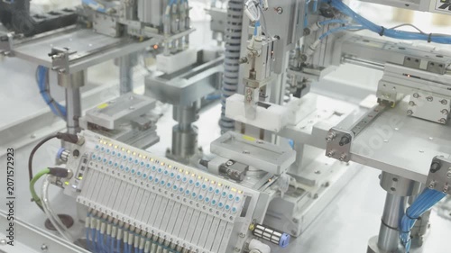 Pneumatic robotic arm in industrial automation system. Automated manufacturing process simulation in smart factory environment.