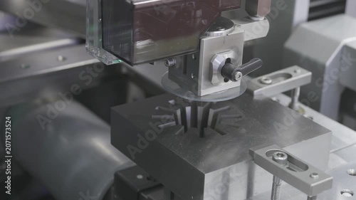 EDM Wire cutting machine working, Closeup Wire Electrical Discharge Machining high precision cut.