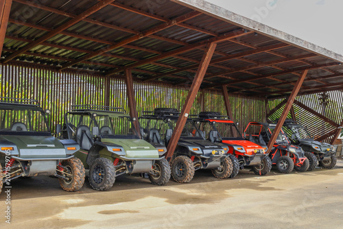 Quadro su tela Row Of Off Road Buggies Parked Neatly Under A Wooden Shelter