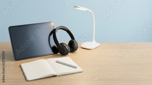 Minimalist Desk Setup with Tablet Headphones and Notebook