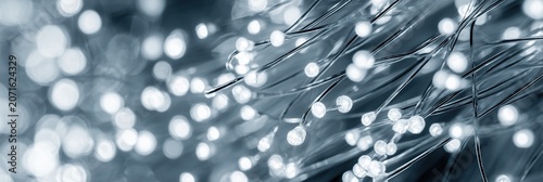 Fiber optic cables with glowing white light dots, representing digital technology and communication
