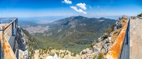 Fotografija Wide angle panorama of mountain valley from high altitude observation deck with wooden railing
