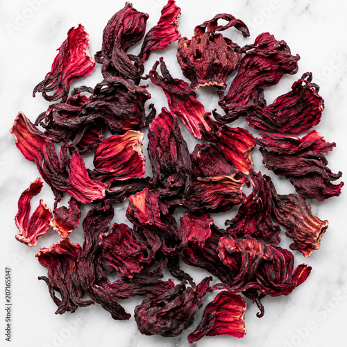 Dried hibiscus flowers or roselle calyces on a marble background