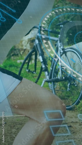 Vertical video: Cyclist stopping bike leaning on low wall stretching after ride with HUD overlaid