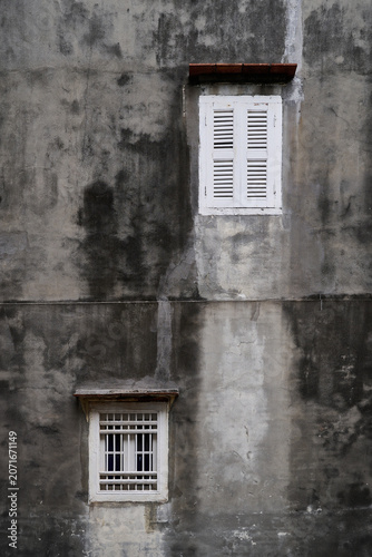 Weathered Concrete Wall with Traditional White Windows