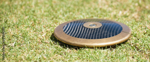 Close up of discuses on grass after impact on grass. Discus throw