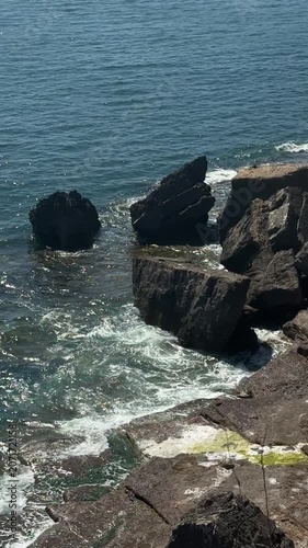 Ocean waves washing around rugged coastal rocks