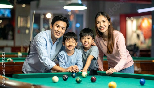 Happy Asian Family Playing Pool Together.