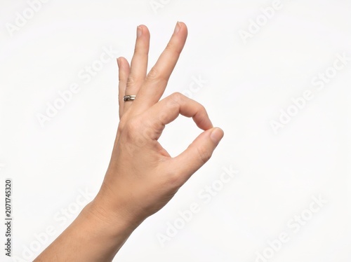 Human hand showing okay gesture sign isolated on white background for success symbol