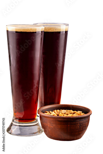 Tall glass filled with golden beer, showcasing thick frothy head, emphasizing refreshing qualities of beverage in minimalist setting. Isolated