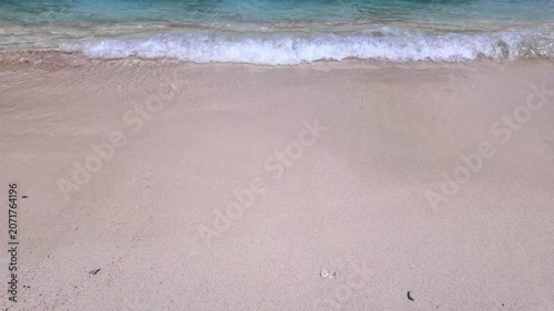 static shot of ocean with calm waves reaching shore of white sand beach on tropical during sunny day, holidays, vacations, relax, paradise and tourism concept, copy space