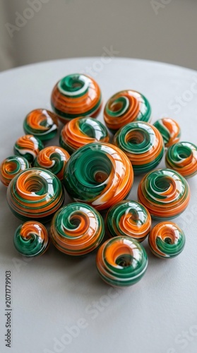 Colorful swirly glass beads in orange and green hues