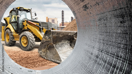 Fotografía A backhoe loader is working at a construction site, moving dirt and preparing th