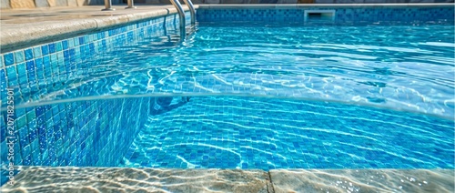 Recreational artwork showing pool with shimmering reflections, blue mosaic tiles, and metal ladder at stone edge