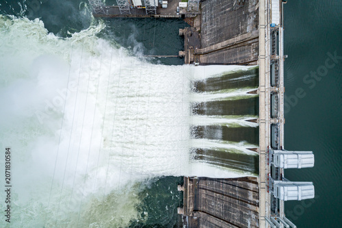 Bild auf Leinwand Aerial top down view of water discharge at hydroelectric power plant