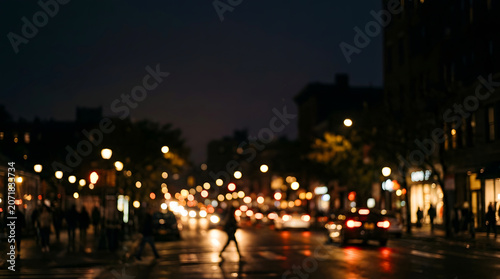 Blurred city night street scene with glowing traffic lights and silhouettes of people walking on sidewalks