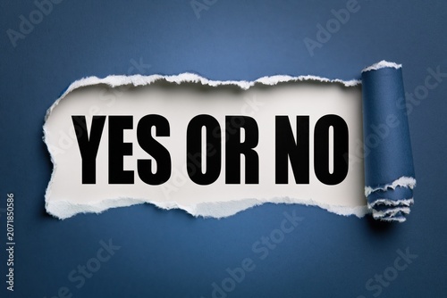 yes or no phrase written on white paper under torn blue paper