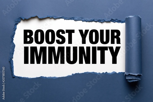 Boost your immunity phrase on white paper under torn blue paper