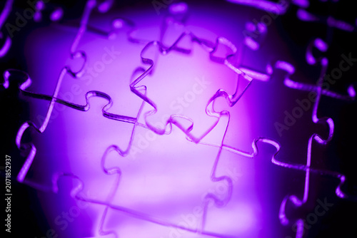 Foto Close-up of interlocking puzzle pieces illuminated by purple light, showcasing i