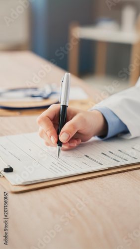 Fotografie Medical doctor completing administrative healthcare records