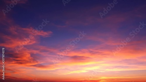 Beautiful sunset sky with orange and purple clouds at dusk