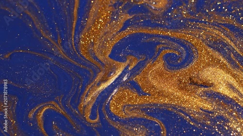 Abstract blue and gold liquid paint mixing together