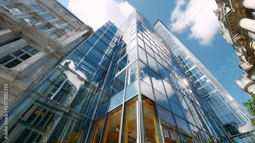 Modern Skyscraper Architecture: A sleek, contemporary skyscraper with a glass facade reflects the sky and surrounding buildings, showcasing modern urban design and architectural innovation.